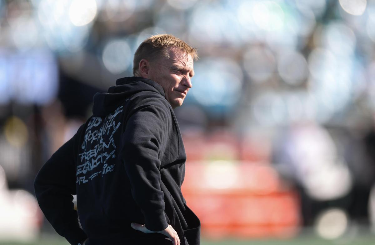 Carolina Panthers interim coach Chris Tabor watches players warm up at the Bank of America Stadium in Charlotte, N.C., on Sunday, December 24, 2023.