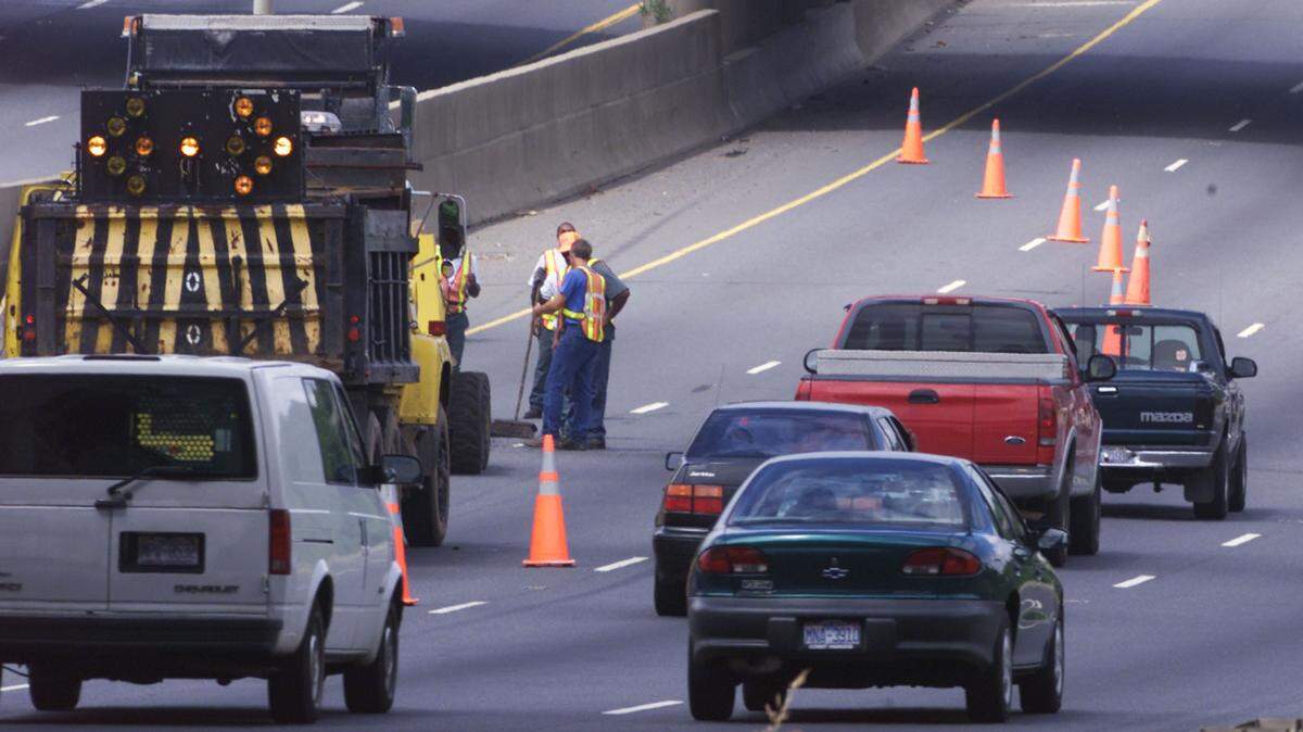 A crew from the N.C. Department of Transportation works to repair a large bump in a southbound lane of I-85 near I-77 in Charlotte in 2001. North Carolina could receive at least $8.7 billion in federal funding over the next five years for highways, bridge replacement, public transportation, electric vehicles and broadband internet under an infrastructure bill passed by the U.S. Senate.
