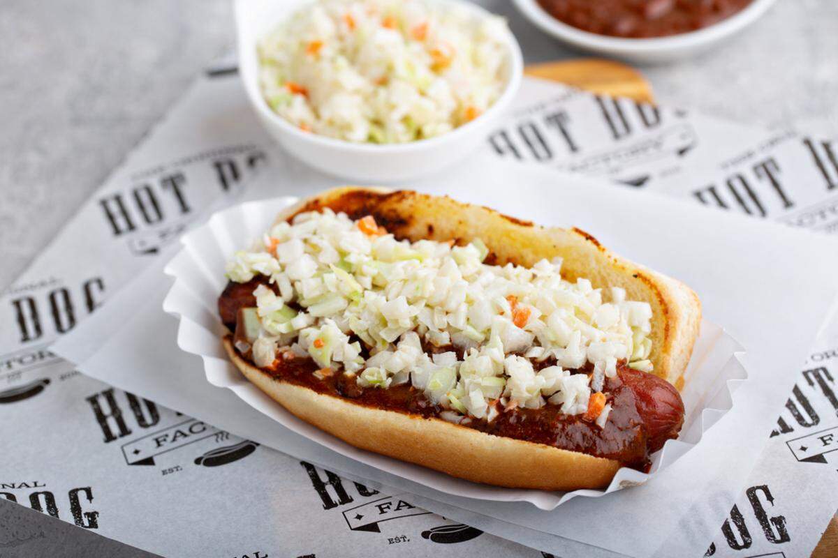 The Original Hot Dog Factory’s Carolina Slaw Dog is the store’s flagship item, featuring Factory chili and Factory slaw.