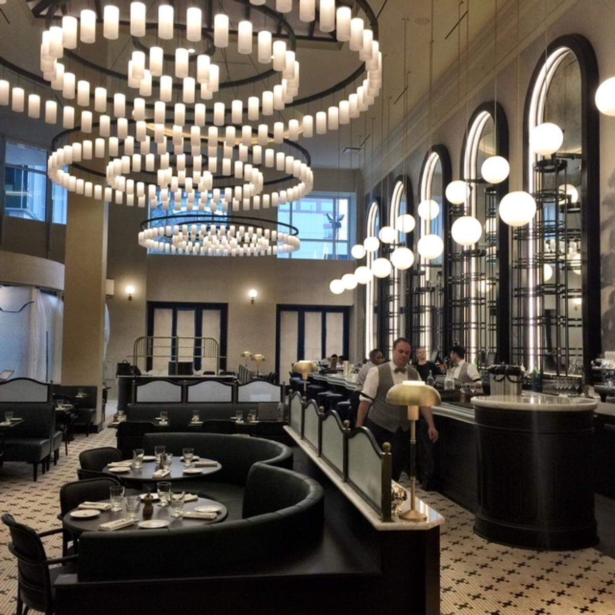 Dramatic lighting stands out in La Belle Helene's muted colors of dark green, black, white and gray.