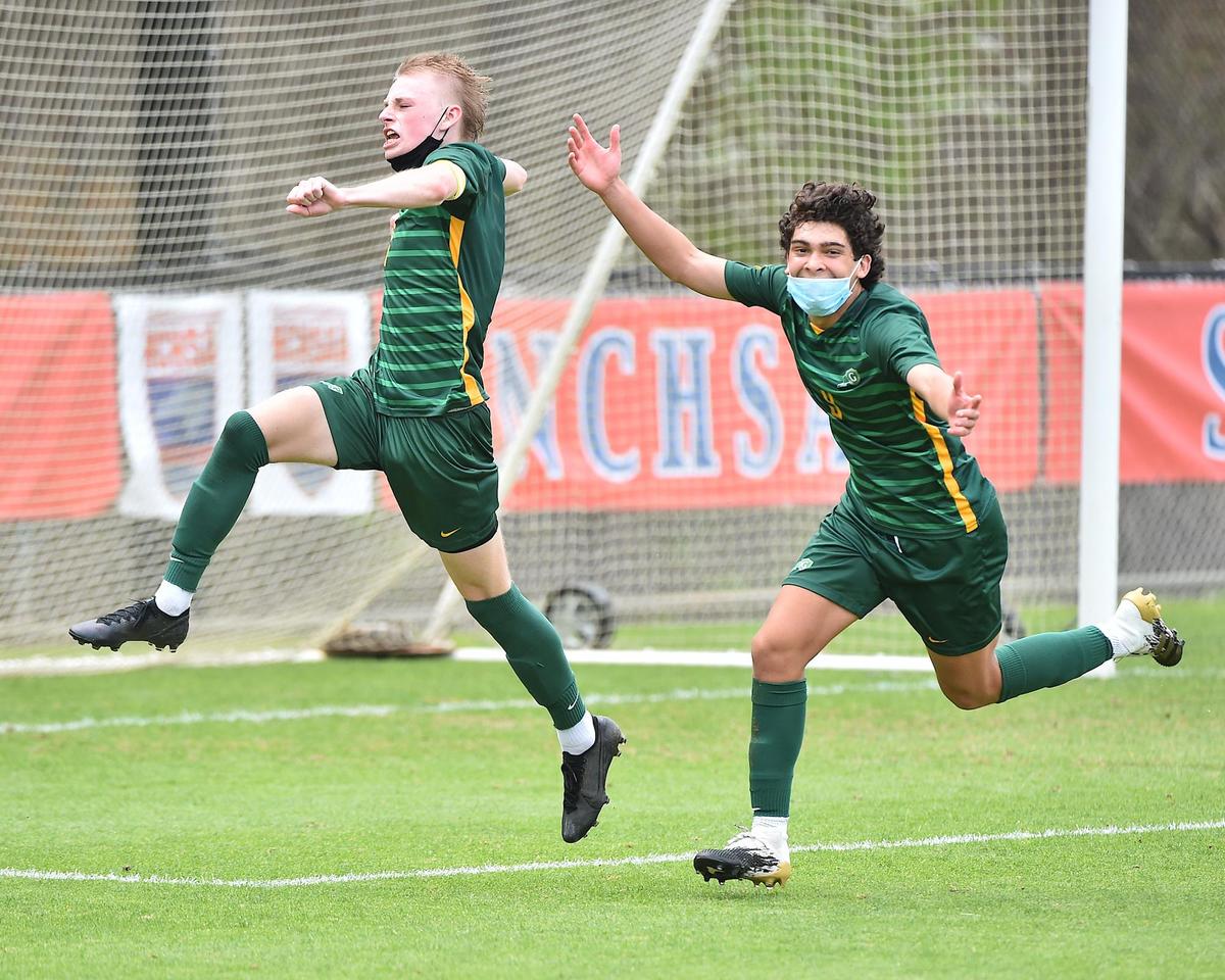 Cardinal Gibbons’ Dean Mercer (7) leaps and celebrates with Alex Perez (9) after Mercer’s goal off the penalty kick during the second half.The Cardinal Gibbons Crusaders and the Myers Park Mustangs met in the NCHSAA 4A Boys Soccer Championship game in Cary N.C. on March 27, 2020