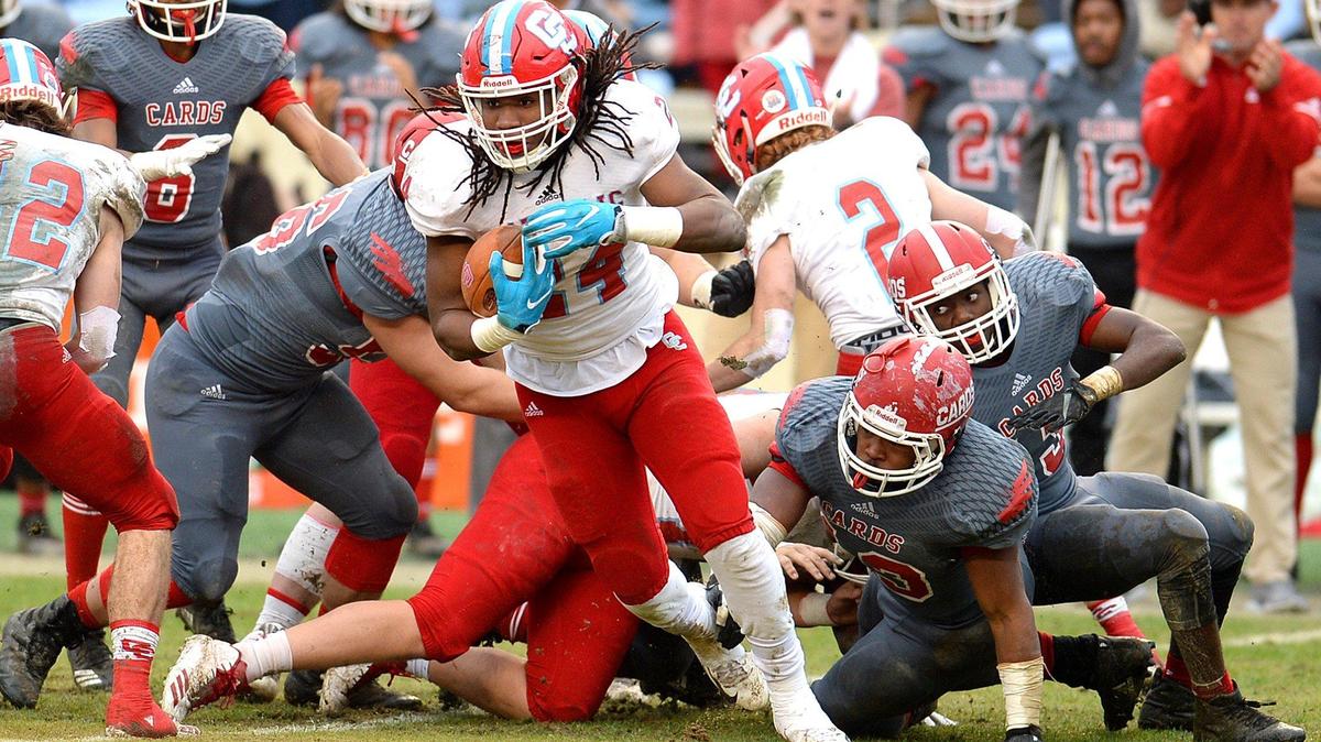 Charlotte Catholic running back Lamagea McDowell, center, spins to rush for yardage during first quarter action against the Jacksonville Cardinals during 2018 3A Championship action at Kenan Memorial Stadium in Chapel Hill, NC on Saturday, December 15, 2018. Catholic defeated Jacksonville 17-14.