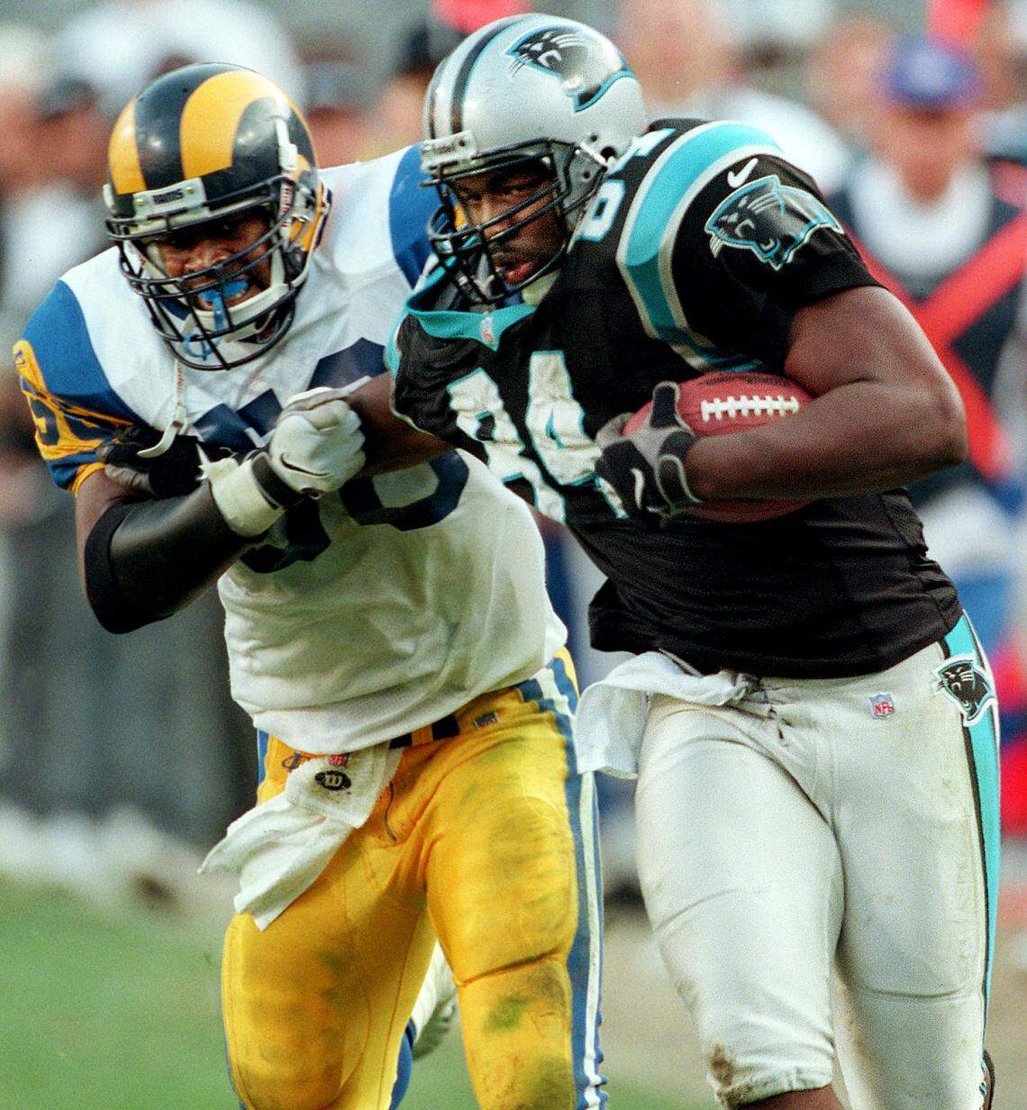 Carolina Panthers tight end Luther Broughton (84) fights off St. Louis Rams defender Roman Phifer in 1998 following his reception of a Steve Beuerlein pass. Broughton scored on the play from 68 yards out.