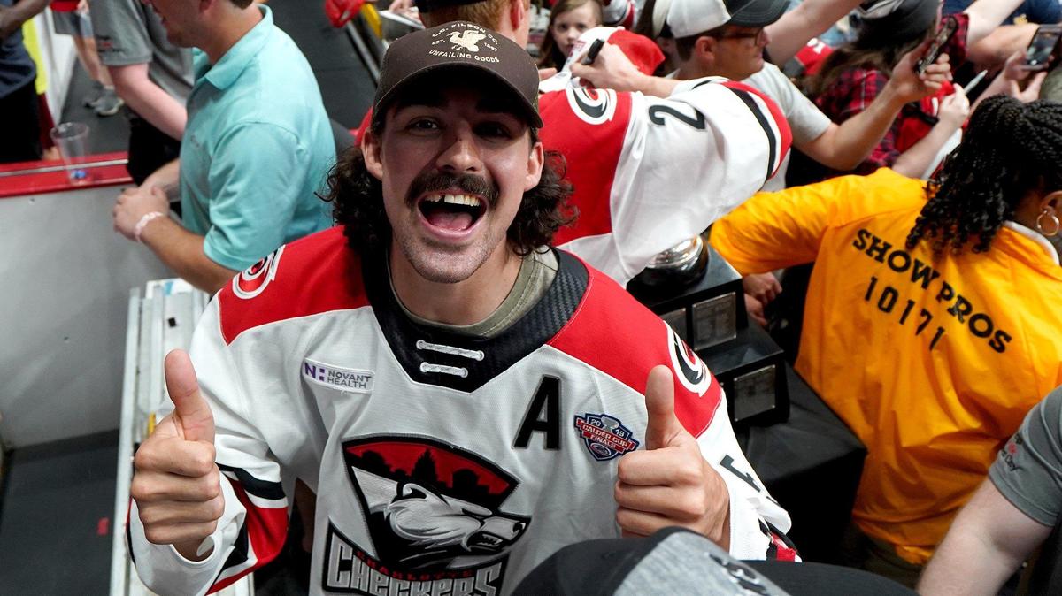 Charlotte Checkers defenseman Trevor Carrick gives thumbs-up as he leaves the team’s Calder Cup championship rally at Bojangles’ Coliseum on Monday.