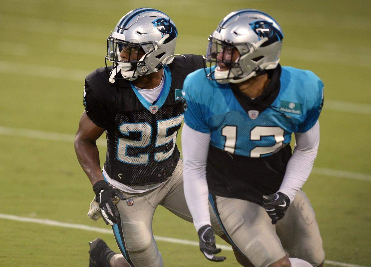 Carolina Panthers cornerback Troy Pride Jr., left, applies pressure on wide receiver DJ Moore, right, during practice at Bank of America Stadium on Wednesday, August 26, 2020.