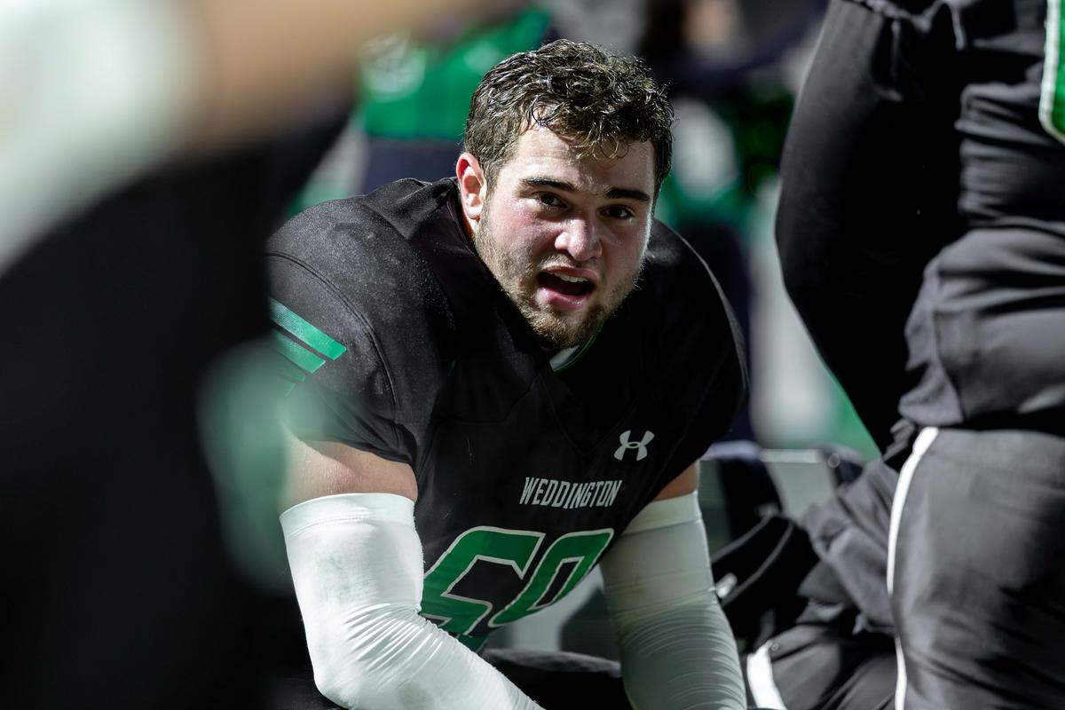 Weddington's Ethan Van Order (center) comes to the sideline after a Warrior's touchdown. Weddington would host Independence in the NCHSAA quarterfinal playoff game Friday, November, 28 2025.