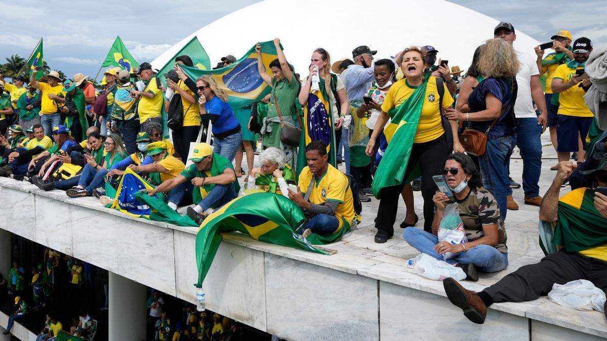 Protesters, supporters of Brazil’s former President Jair Bolsonaro, stand on the roof of the National Congress building after they stormed it, in Brasilia, Brazil, Sunday, Jan. 8, 2023.
