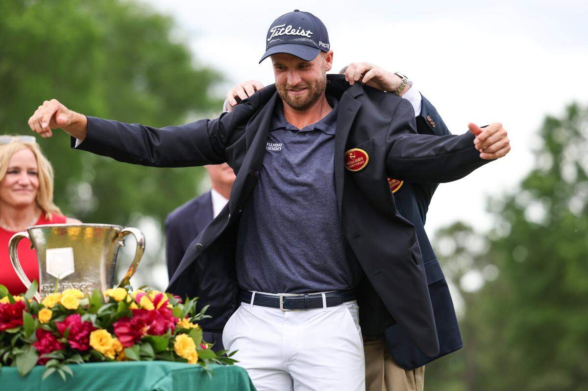 Wyndham Clark puts on the championship blazer after winning the Wells Fargo Championship on Sunday, May 7, 2023 at Quail Hollow Club. This is Clark’s first major tour win.