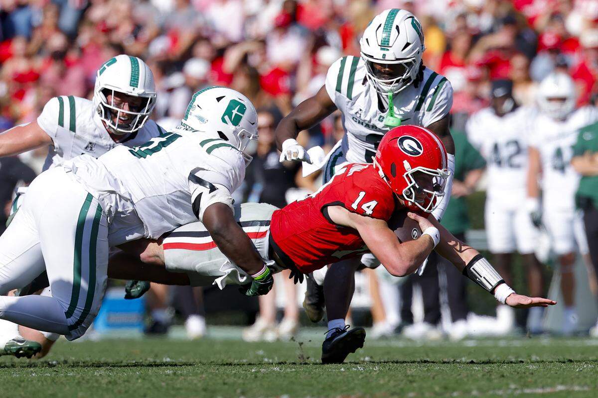 Gunner Stockton (14) of the Georgia Bulldogs scrambles during the first quarter against the Charlotte 49ers at Sanford Stadium on Nov. 22, 2025 in Athens, Georgia.
