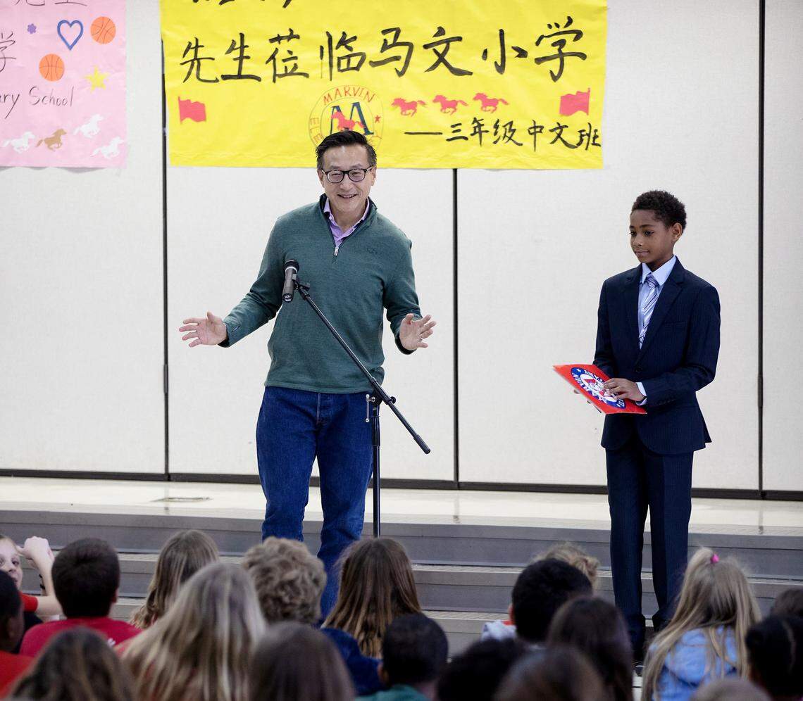 Joseph Tsai, co-founder of Alibaba and owner of the Brooklyn Nets, speaks to students in the Chinese immersion program at Marvin Elementary and two neighboring middle schools. He later gave the school 30 tickets to the NBA All-Star Game. To his right is David Smith Jr., 11, who met Tsai while visiting China in November.