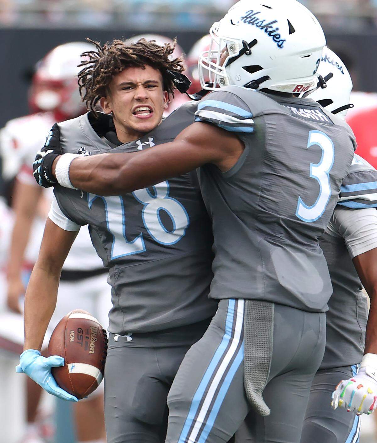 Hough Huskies defensive back Drew Johnson, left, celebrates his interception of a pass by South Pointe Stallions quarterback J’Zavien Currence during the Keep Pounding Classic at Bank of America Stadium in Charlotte, NC on Friday, Aug. 22, 2025.