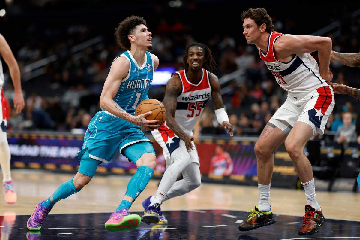 Charlotte Hornets guard LaMelo Ball (1) dribbles the ball as Washington Wizards center Mike Muscala (35) defends in the second quarter at Capital One Arena.