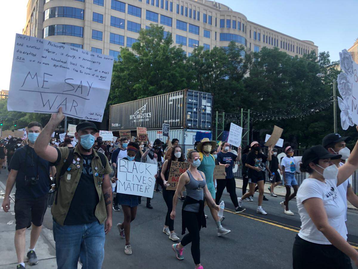 Protesters march through uptown Charlotte chanting “Black Lives Matter” and “Hands up, don’t shoot,” on Sunday, June 7, 2020.