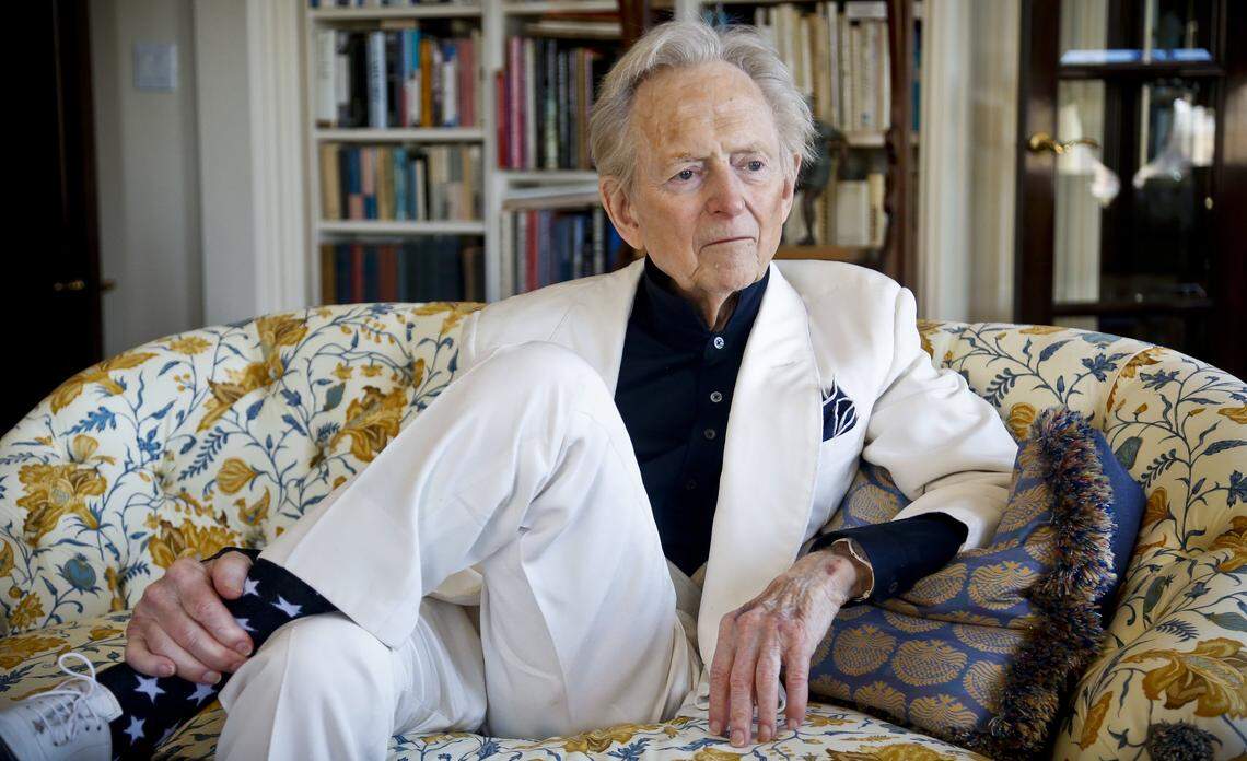 Author and journalist Tom Wolfe appears in his New York living room during a 2016 interview. Wolfe's 1965 magazine article on NASCAR driver Junior Johnson helped propel the sport to national attention.