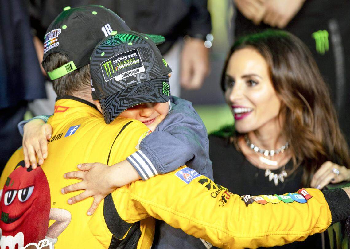 Kyle Busch (18) hugs his son Brexton Locke Busch next to his wife Samantha after winning the Homestead-Miami Speedway NASCAR 21st Annual Ford EcoBoost 400 Monster Energy Series in Homestead, Florida on Sunday, Nov. 17, 2019.