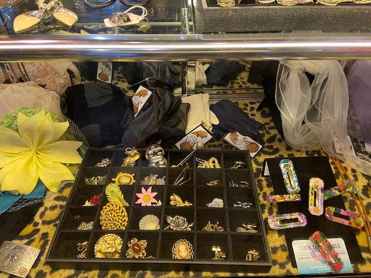 Vintage accessories stand out against a leopard print showcase at Stash Pad.