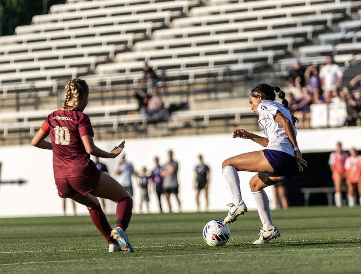 Ardrey Kell brings the ball down past her defender