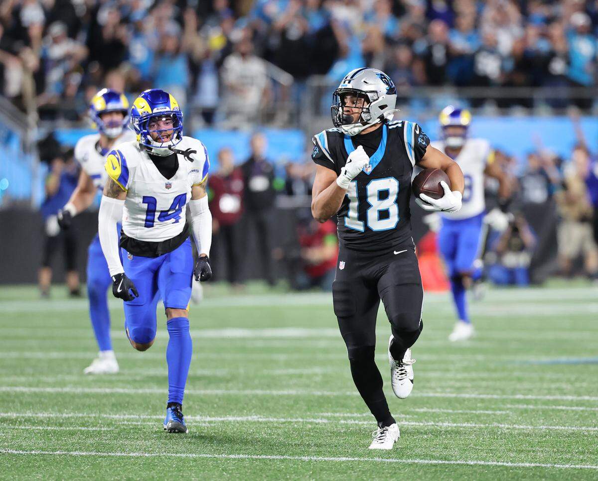 Carolina Panthers Jalen Coker rushes for yardage against Los Angeles Rams Cobie Durant during the wild card playoff game at Bank of America Stadium on Saturday, Jan. 10, 2025 in Charlotte.