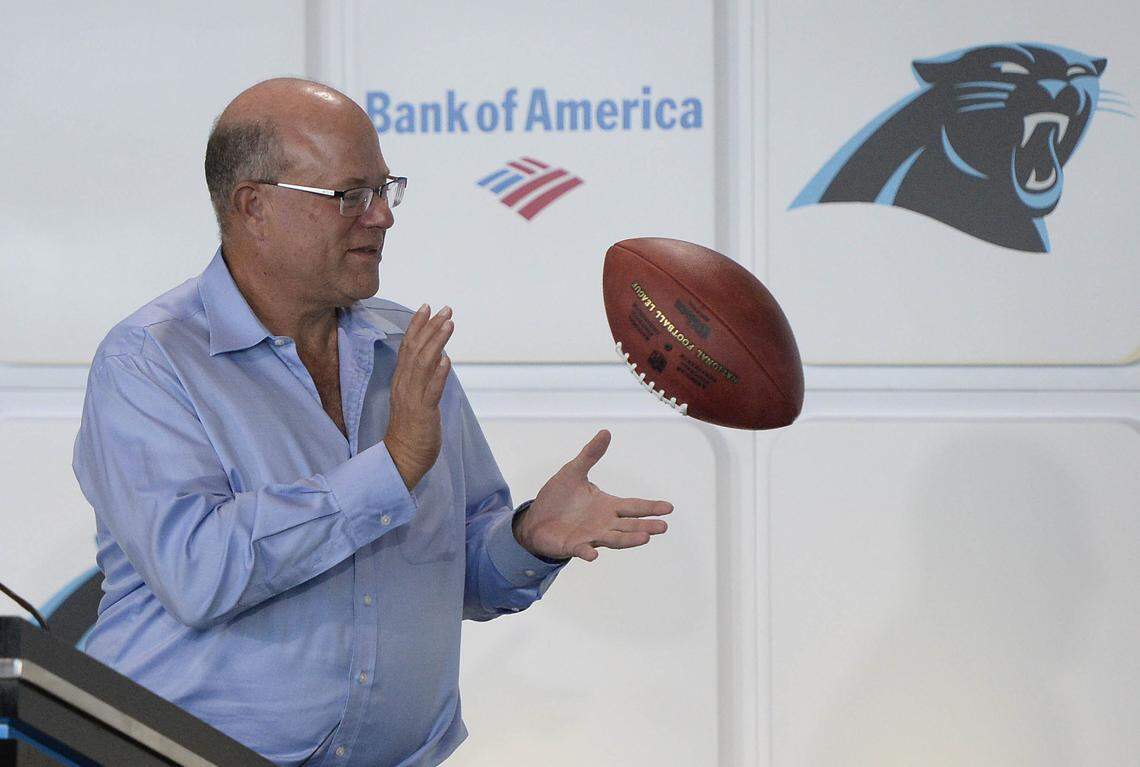 Billionaire hedge-fund manager David Tepper, the new owner of the Carolina Panthers, reaches out for a ceremonial ball tossed to him at the conclusion of his introductory press conference at Bank of America Stadium on July 10. Tepper is already shaking things up on Mint Street.