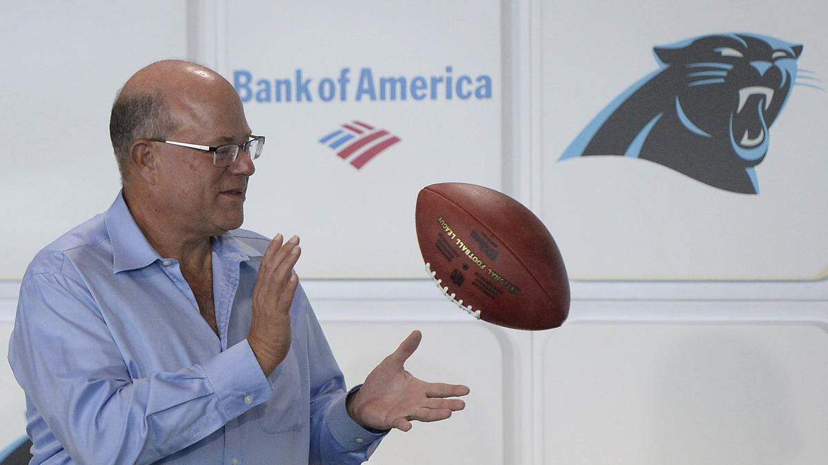 Billionaire hedge-fund manager David Tepper, the new owner of the Carolina Panthers, reaches out for a ceremonial ball tossed to him at the conclusion of his introductory press conference at Bank of America Stadium on July 10. Tepper is already shaking things up on Mint Street.