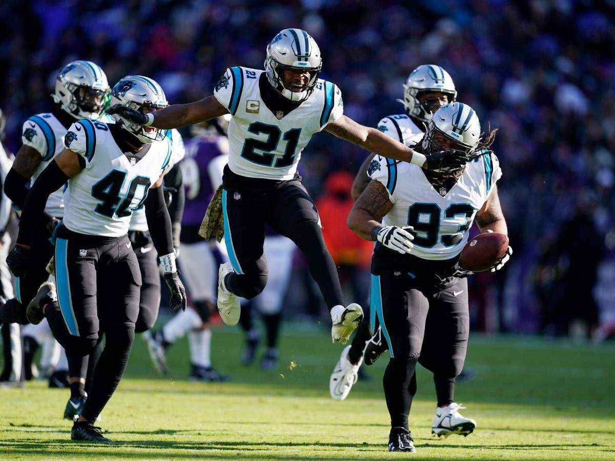 Carolina Panthers defensive tackle Bravvion Roy (93) and teammate safety Jeremy Chinn (21) celebrate an interception in the first half of an NFL football game against the Baltimore Ravens Sunday, Nov. 20, 2022, in Baltimore. (AP Photo/Patrick Semansky)