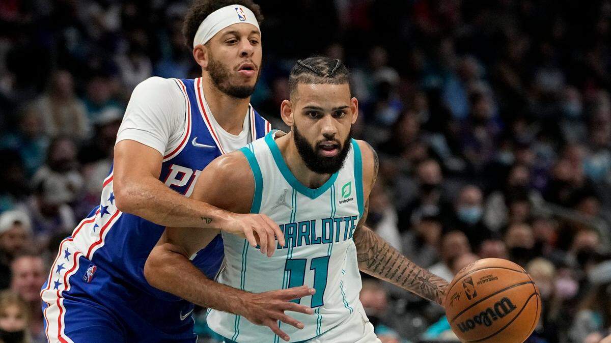 Charlotte Hornets forward Cody Martin drives to the basket past Philadelphia 76ers guard Seth Curry during the first half of an NBA basketball game on Monday, Dec. 6, 2021, in Charlotte, N.C. (AP Photo/Chris Carlson)