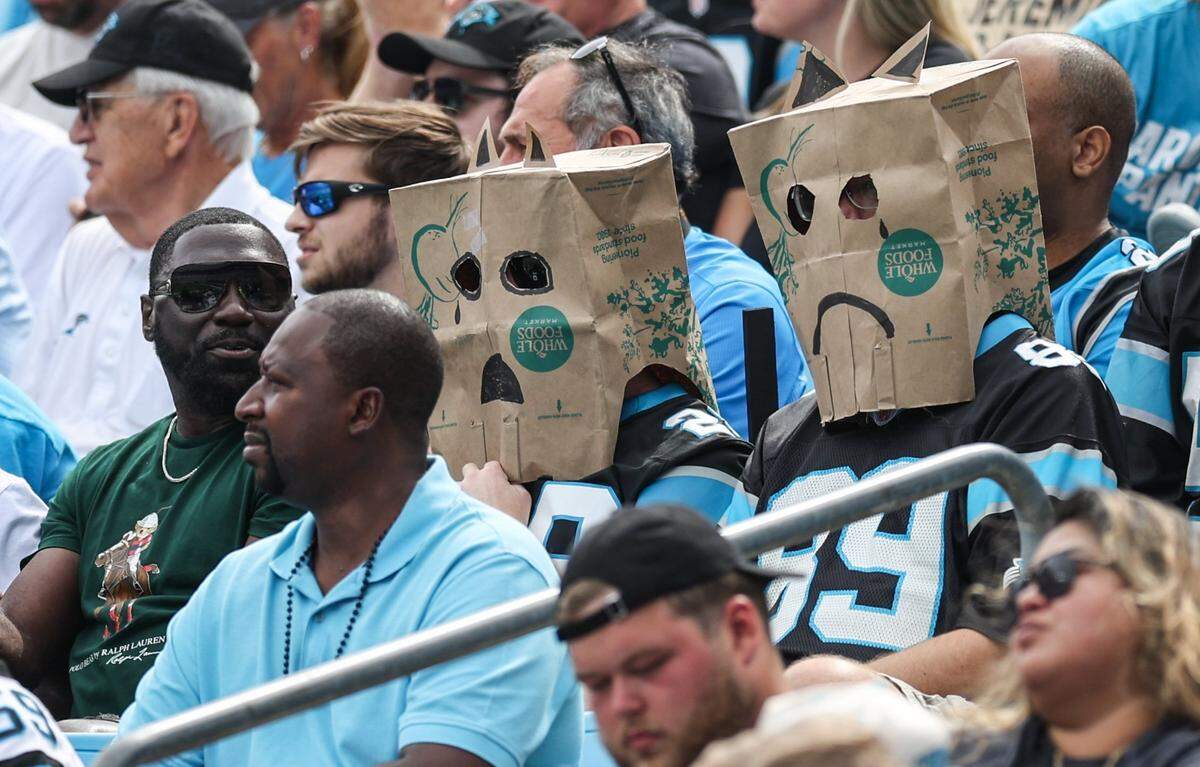 Fans watch the game with paper bags over their heads during the game against the Chargers at Bank of America Stadium in Charlotte, NC on Sunday, September 15, 2024. The Panthers lost to the Chargers, 26-3, giving them an 0-2 record so far for this season.