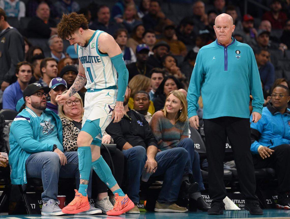 Charlotte Hornets guard LaMelo Ball, left, gingerly walks to the team’s bench in 2022 after injuring his left ankle. Hornets coach Steve Clifford (right) looks on. In Clifford’s two most recent seasons as the head coach, Ball played in only 35% of the team’s games due to injury.