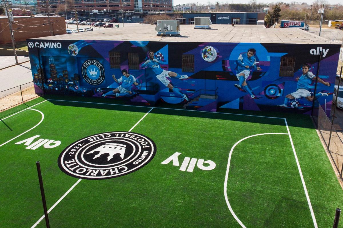 A mural by artist Sydney Duarte and Australian partner Treazy Treaz sits adjacent to a newly built soccer pitch at Camino Health Center in Charlotte, NC, Thursday, March 3, 2022. The turf field will be unveiled on Friday, March 4.