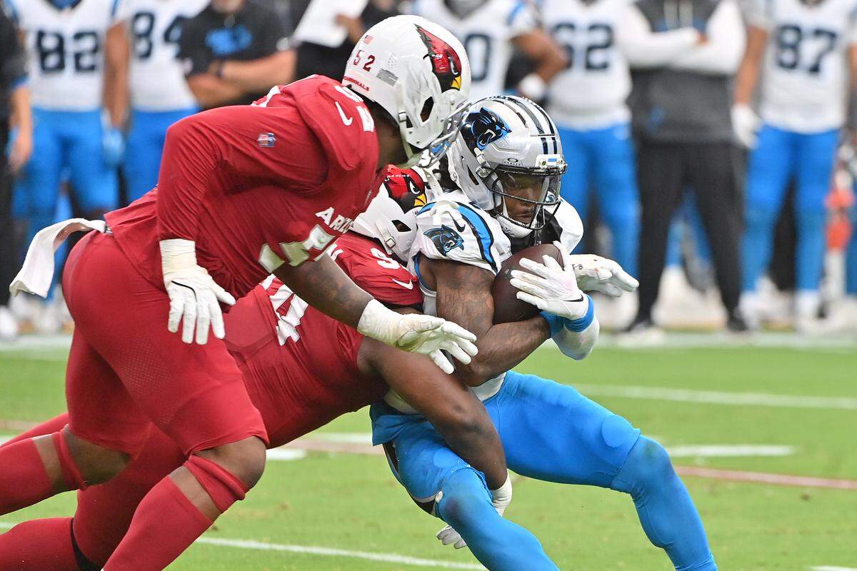 Carolina Panthers quarterback Bryce Young (9) is tackled by Arizona Cardinals defensive tackle Dalvin Tomlinson (94) during the first quarter at State Farm Stadium in Glendale, Ariz., on Sunday, Sept. 14, 2025.