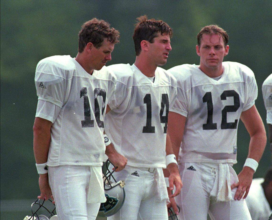 Panthers quarterbacks (left to right) Jack Trudeau, Frank Reich and Kerry Collins huddle at practice Friday, July 21, 1995.