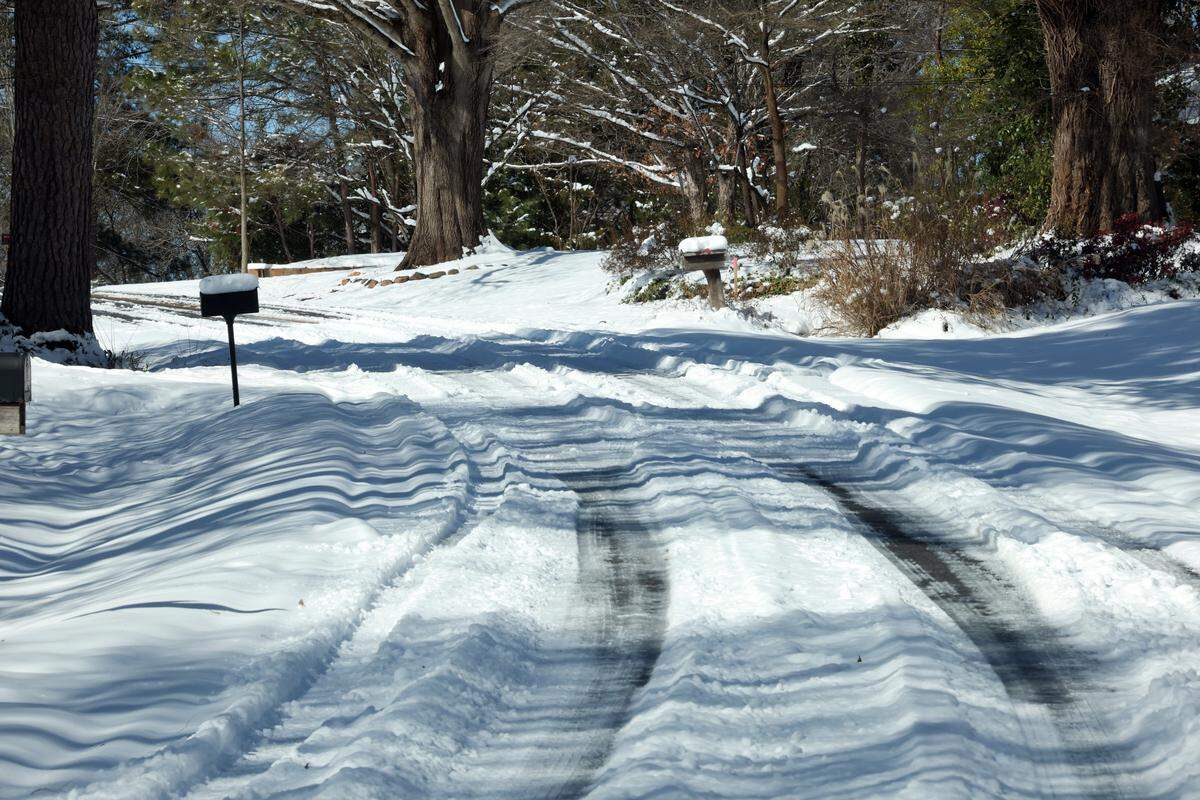 A Rock Hill, S.C. neighborhood road is mainly covered in snow Sunday, Feb. 1, 2026.