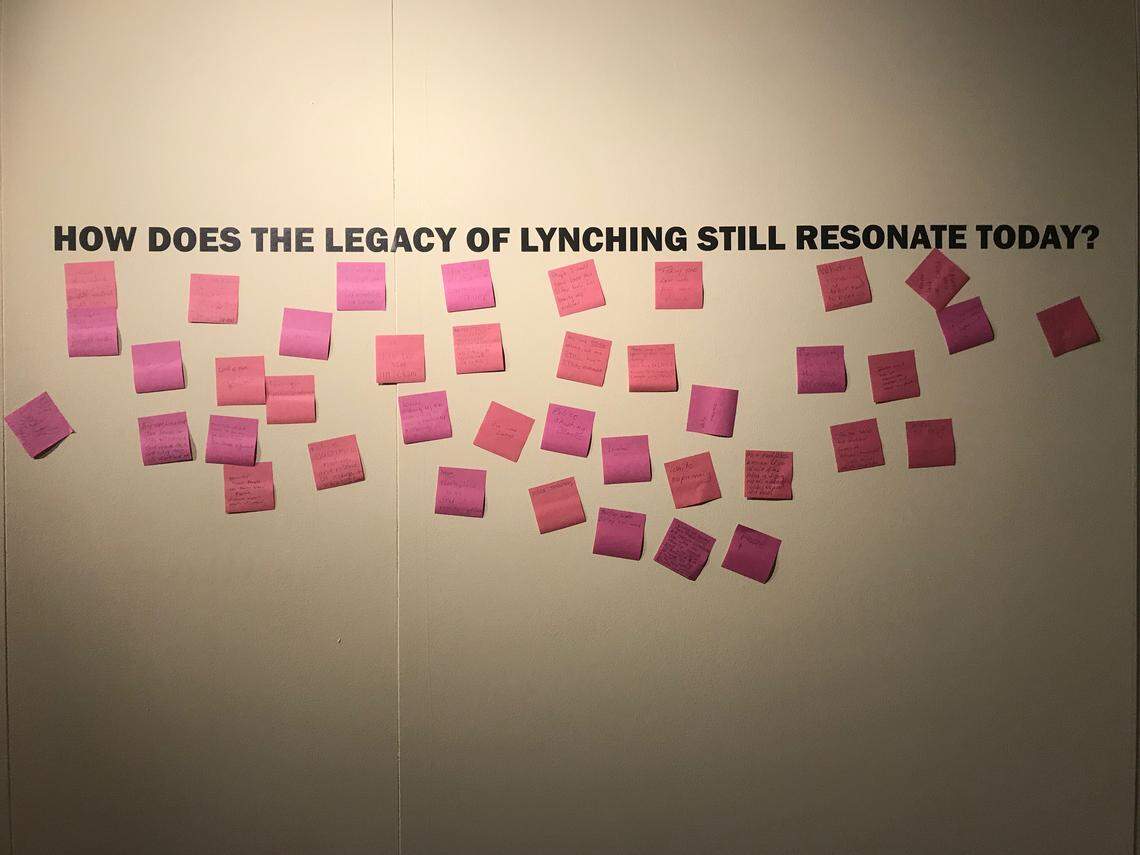 The walls of the Levine Museum of the New South’s “Legacy of Lynching: Confronting Racial Terror in America” exhibit are covered in dozens of pink Post-it notes, put there by people coming face-to-face with this painful part of American history.