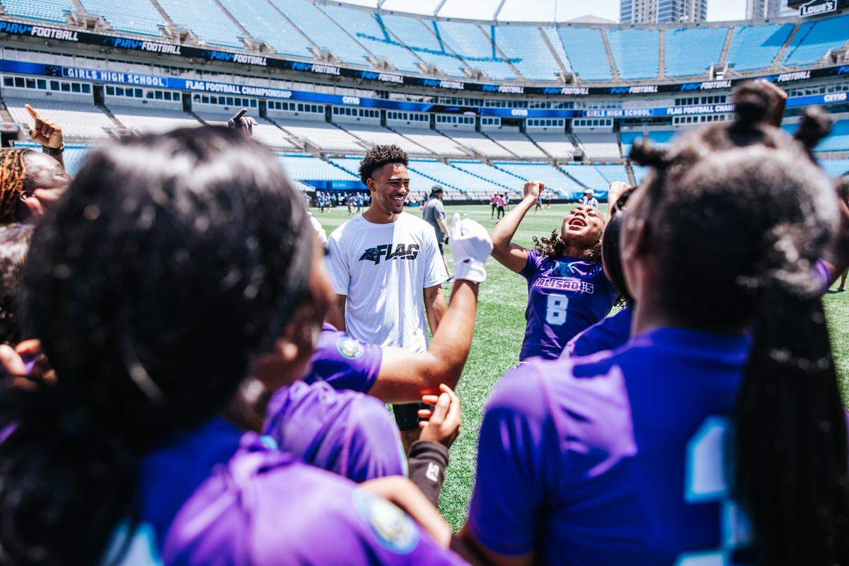Carolina Panthers quarterback Bryce Young encourages flag football players across North Carolina and South Carolina in Bank of America Stadium in May 2025.