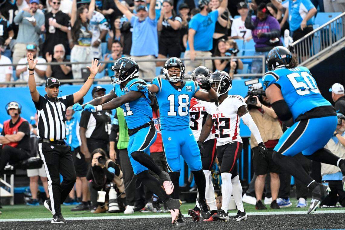 Oct 13, 2024; Charlotte, North Carolina, USA; Carolina Panthers wide receiver Xavier Legette (17) celebrates with wide receiver Jalen Coker (18) after scoring a touchdown in the second quarter at Bank of America Stadium. Mandatory Credit: Bob Donnan-Imagn Images