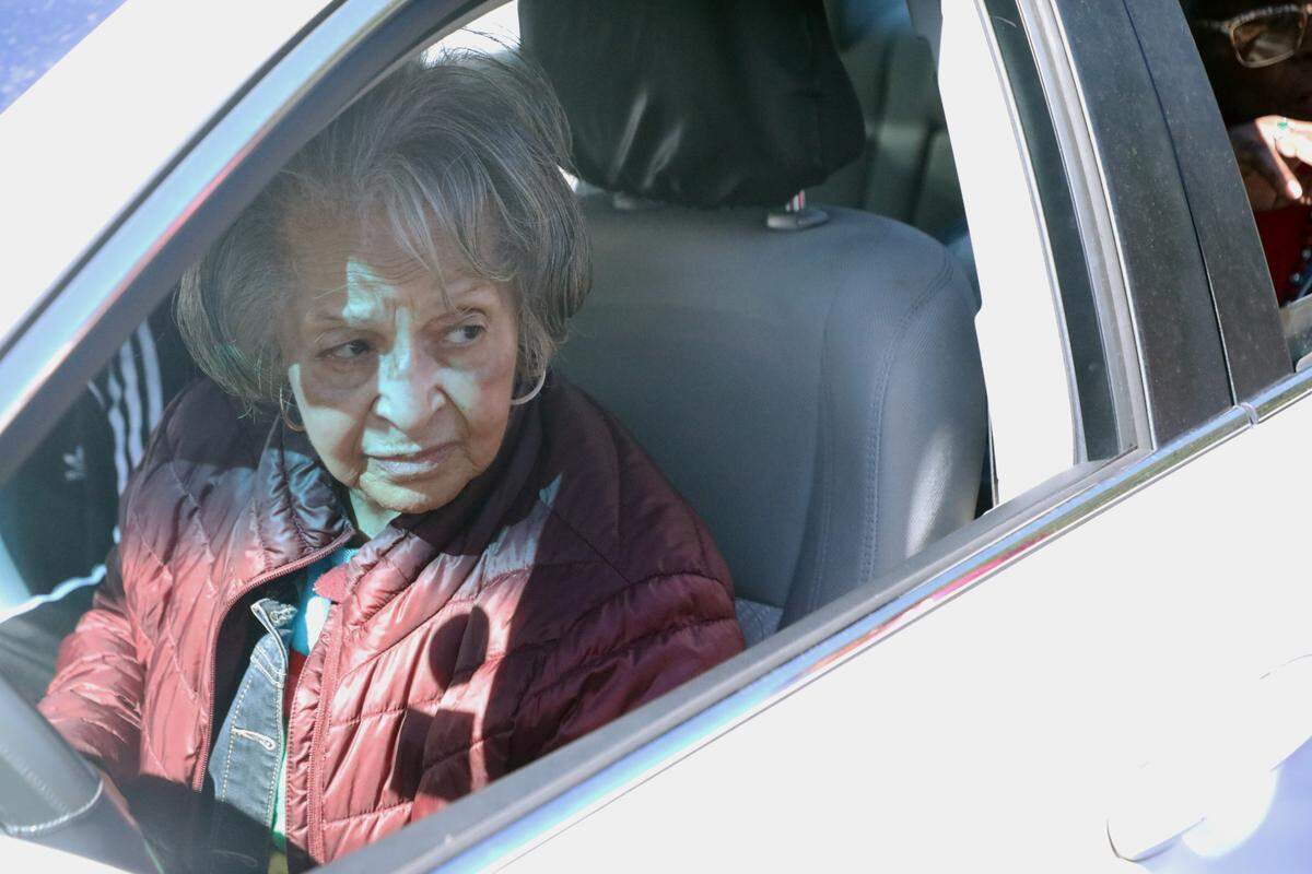 An early voter waits to cast her ballot curbside, an accessible alternative voting option at the Allegra Westbrooks Regional Library polling place in Charlotte, N.C. on October 17, 2024.