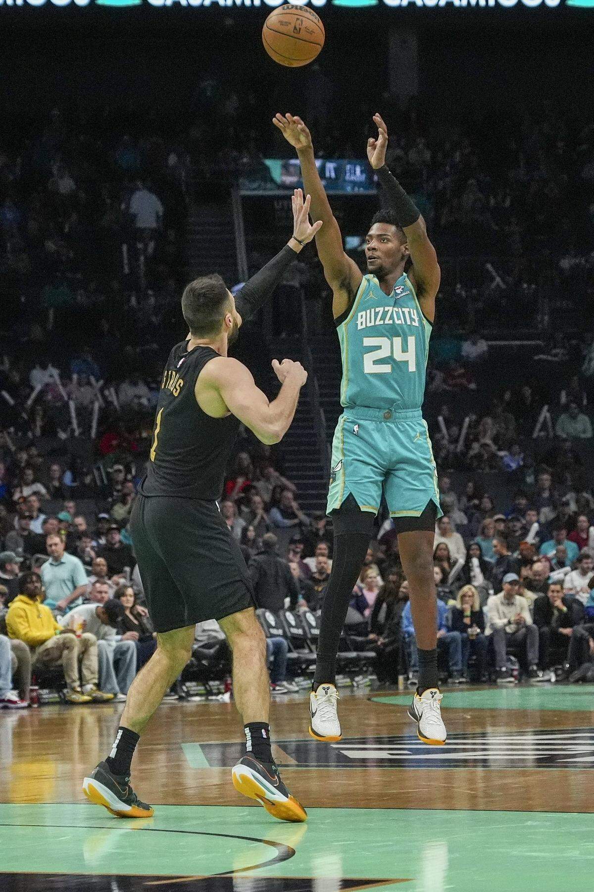 Charlotte Hornets forward Brandon Miller (24) shoots the jumper over Cleveland Cavaliers guard Max Strus (1) during the second half at Spectrum Center.