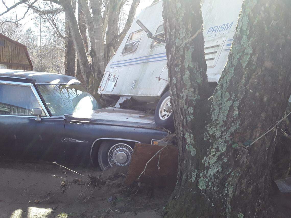 Part of the destruction at the Hiddenite Family Campground in Alexander County Friday, following deadly flooding Thursday. A camper trailer rests partially atop an old hearse that was at the site.