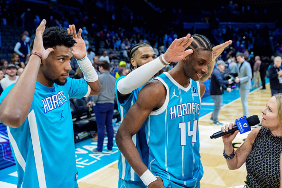 Moussa Diabaté of the Charlotte Hornets is interviewed while Brandon Miller, left, and Miles Bridges, center, look on.