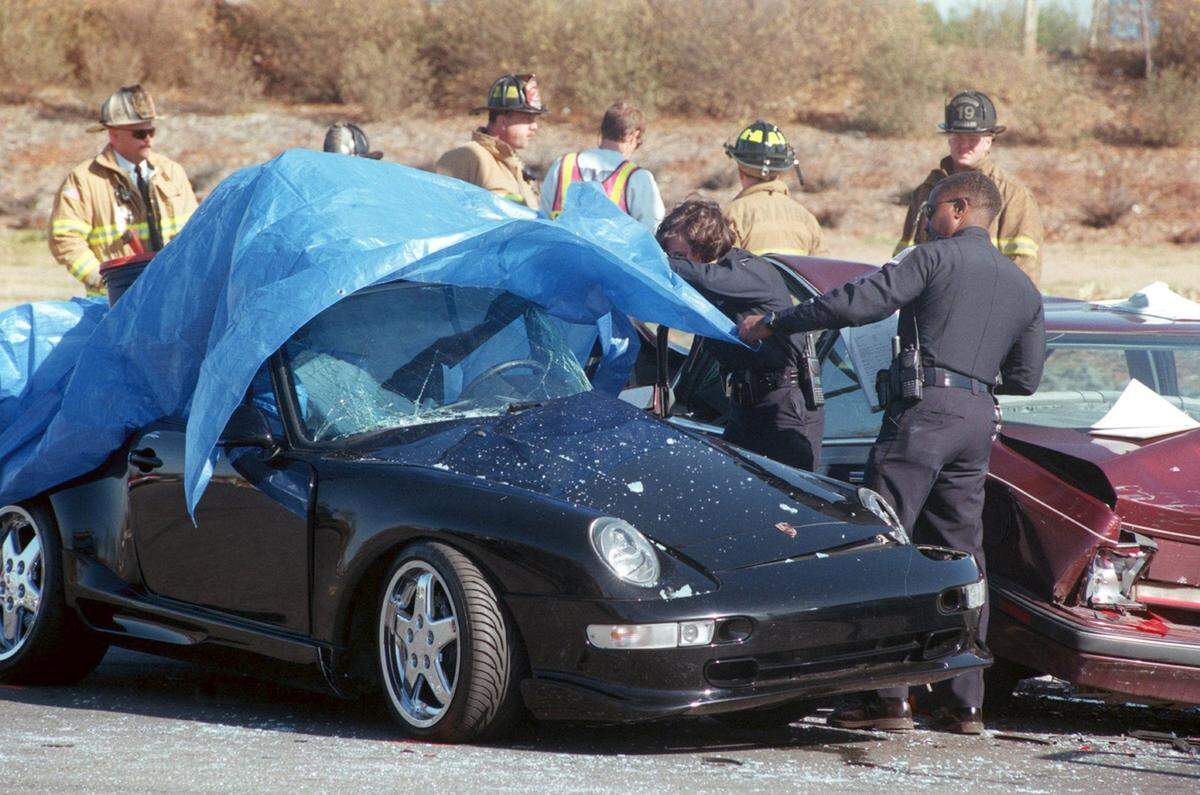 Police look at Bobby Phills' crumpled Porsche on Tyvola Road after a car accident on Jan. 12, 2000. Phills, a standout player for the Charlotte Hornets, died instantly when he skidded into an oncoming Oldsmobile while speeding. He was 30 years old.