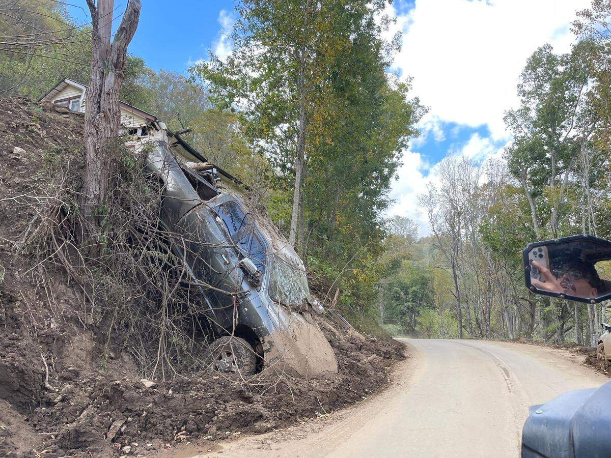 A 6,000-pound RAM 2500 truck sits toppled below Logan Brown’s home between Ingalls and Elk Park, North Carolina. Mangled metal is a common site in Western North Carolina after Hurricane Helene’s bands triggered deadly mudslides, flooding and destruction in Appalachia on Friday, Sept. 27, 2024.