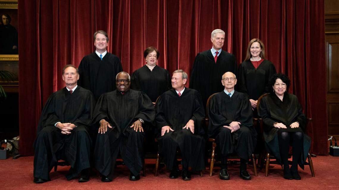 Members of the current US Supreme Court posed for this group photo in April 2021. Chief Justice John Roberts (seated, center) ordered an investigation this week into a leaked draft opinion that would strike down Roe v. Wade.
