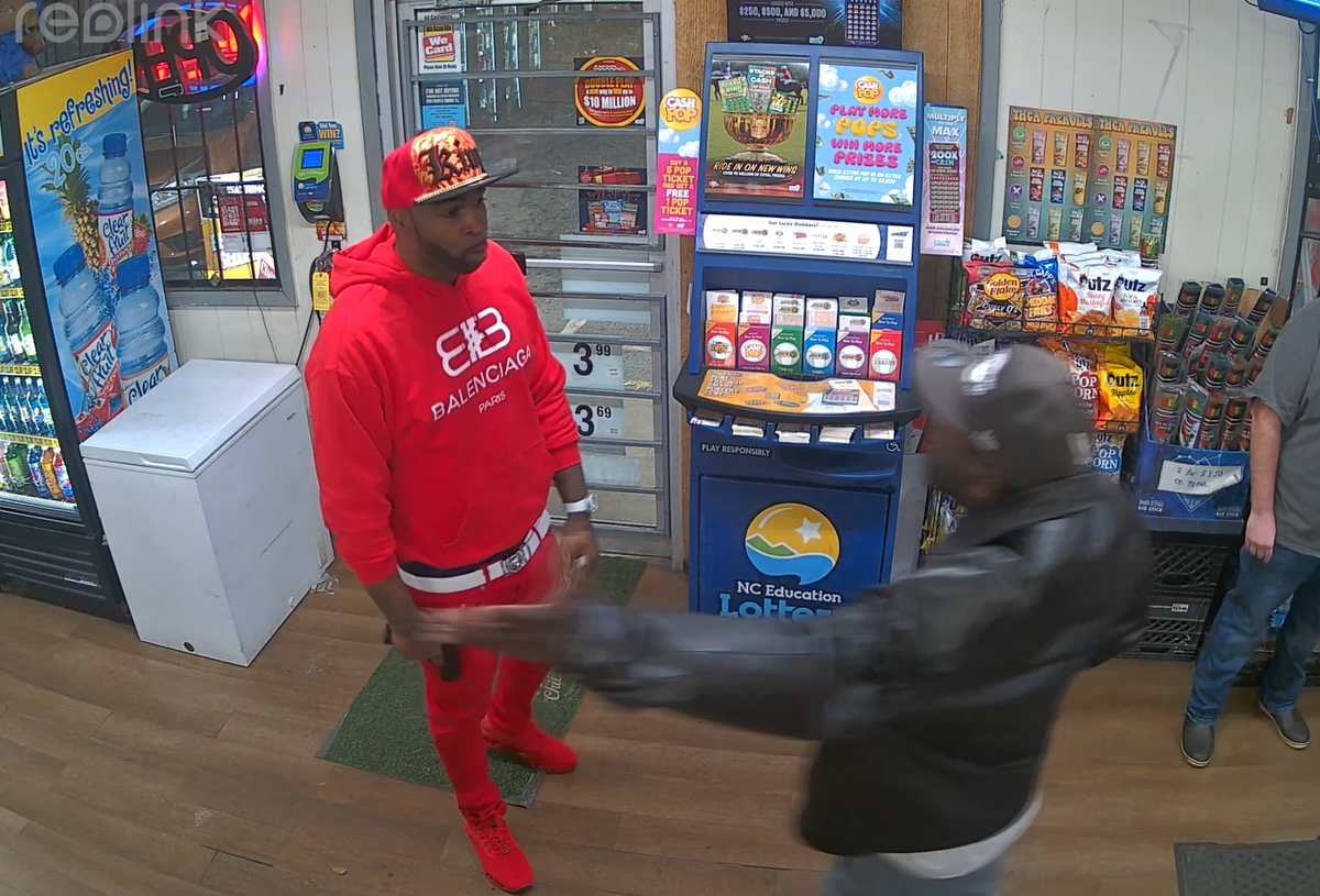 A man trailed Derrick Manigault, in red sweatshirt at left, after they argued outside Jakob’s Food Mart on Jan. 10. Manigault pulled out a fake gun, and an undercover  officer shot him.