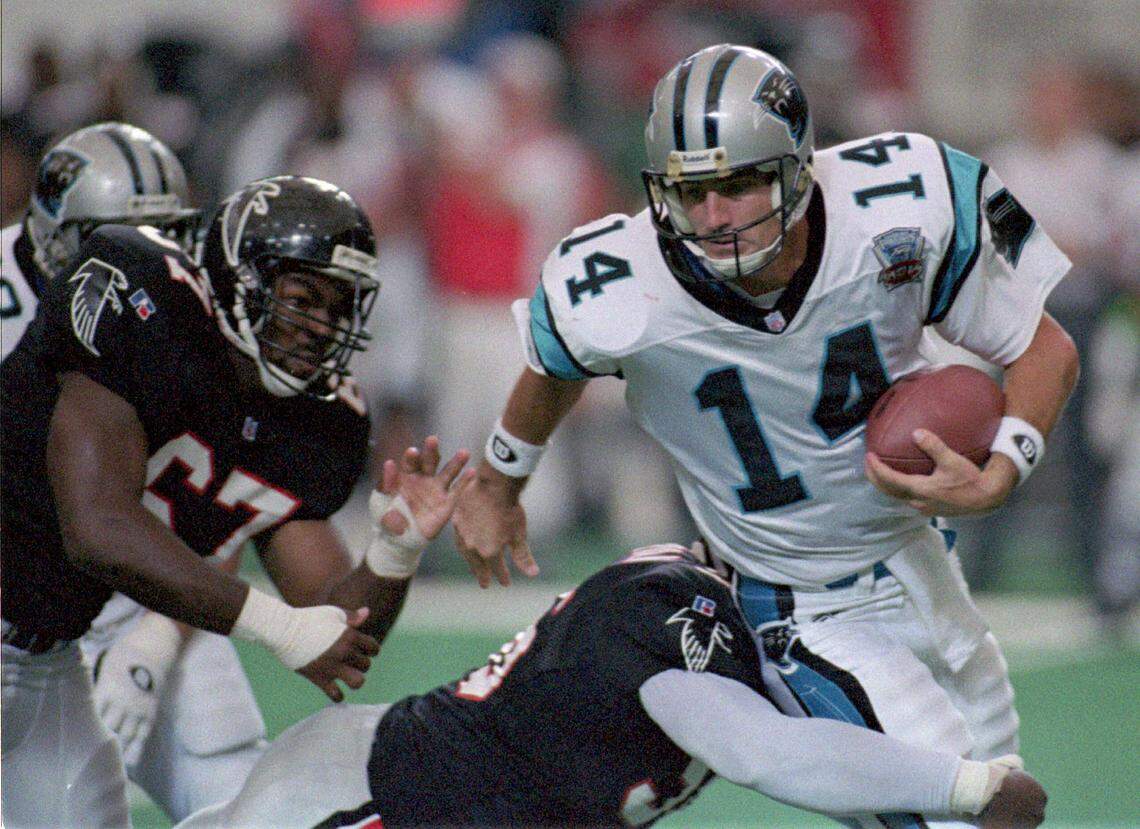 Despite Carolina’s near upset of Atlanta, Panthers quarterback Frank Reich (14) spent much of the day fleeing the Falcons’ pass rush. He was sacked nine times on Sunday, Sept. 03, 1995
