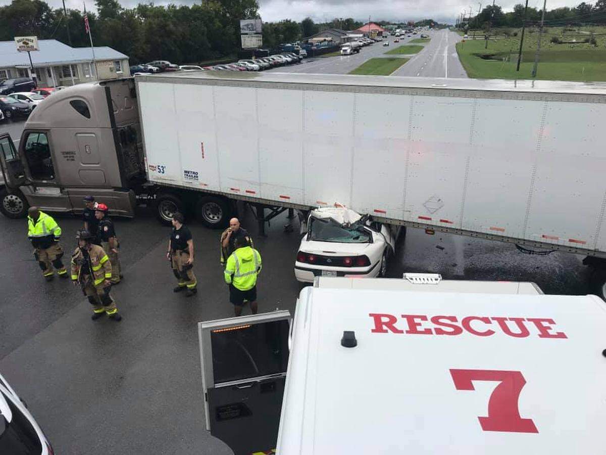 Police in Tennessee said a driver had to be cut from a car after getting wedged under a semi-truck on Wednesday.