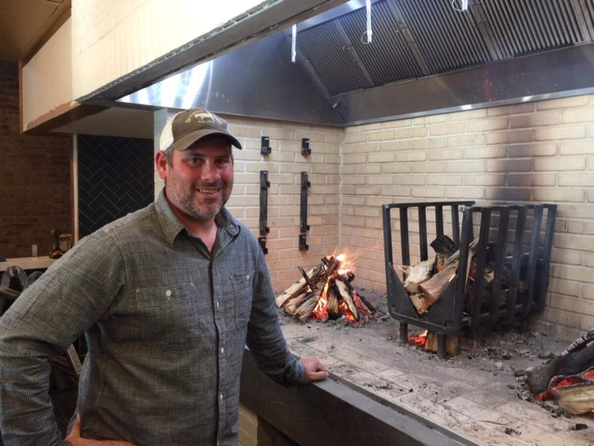 Co-owner Zach Goodyear was testing the fire in the cooking fireplace on Wednesday. When it’s operating, you’ll see whole chickens and other cuts hanging from rods above the fire.