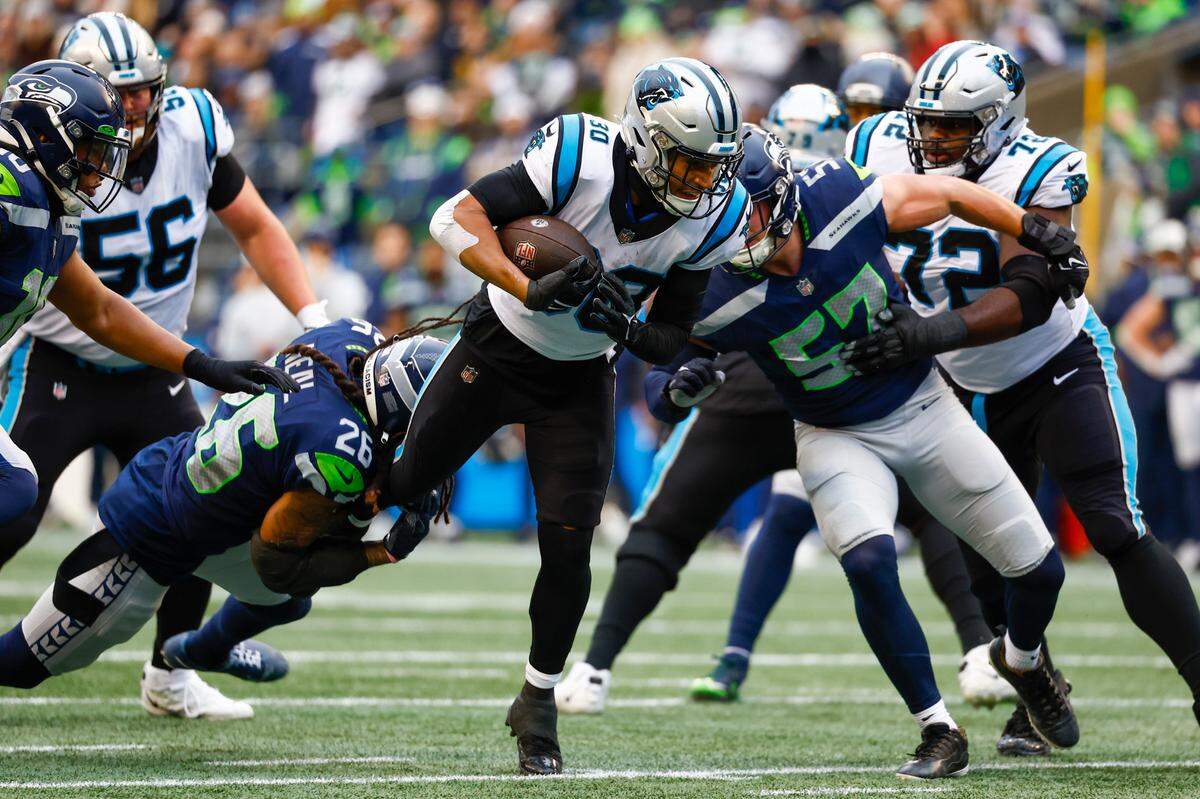 Dec 11, 2022; Seattle, Washington, USA; Carolina Panthers running back Chuba Hubbard (30) rushes against the Seattle Seahawks during the second quarter at Lumen Field. Mandatory Credit: Joe Nicholson-USA TODAY Sports