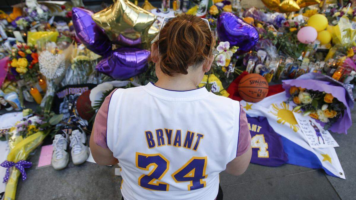 A fan pays her respect at a memorial for Kobe Bryant near Staples Center on Tuesday.
