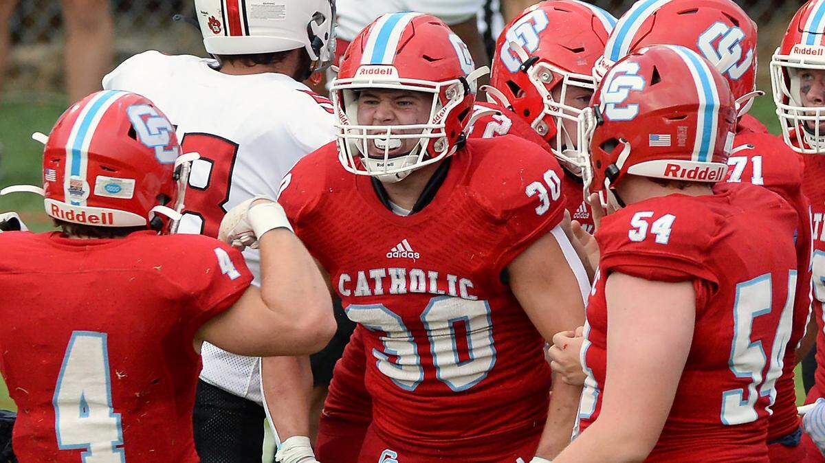 Charlotte Catholic running back Griffin Sovine, center, celebrates his touchdown run against the South Meck Sabres with his teammates during first quarter action on Friday, August 19, 2022.
