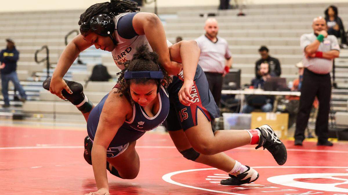 Hopewell Titans Lauren Baker-Perry, bottom, wrestles Mallard Creek Mavericks Samaya Brandon at Ballantyne Ridge High School in Charlotte, N.C., on Thursday, January 23, 2025. 